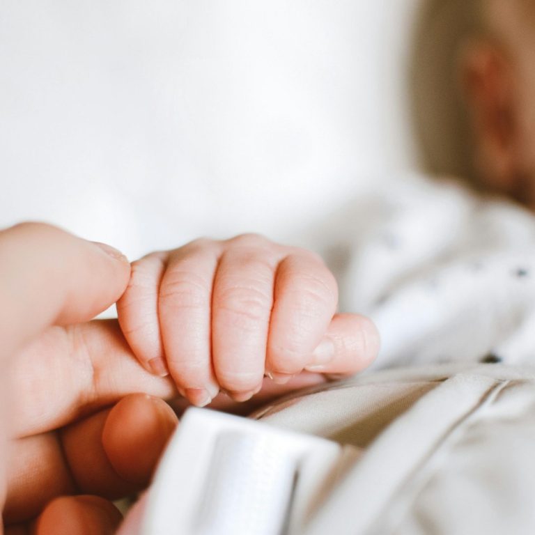 Picture of parent holding baby's hand